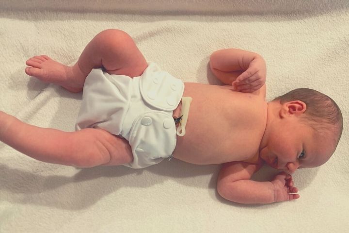 Newborn baby in white washable nappy