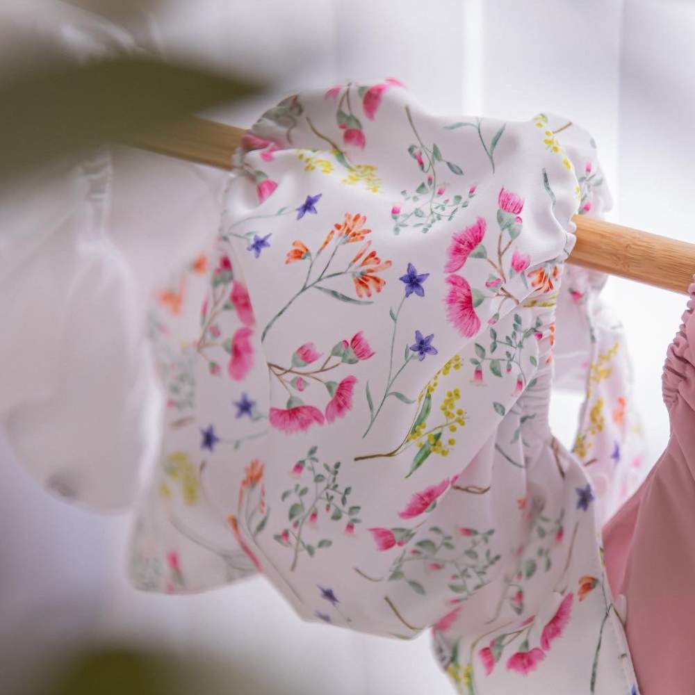 Australian floral reusable nappy cover hanging to dry on the line after washing