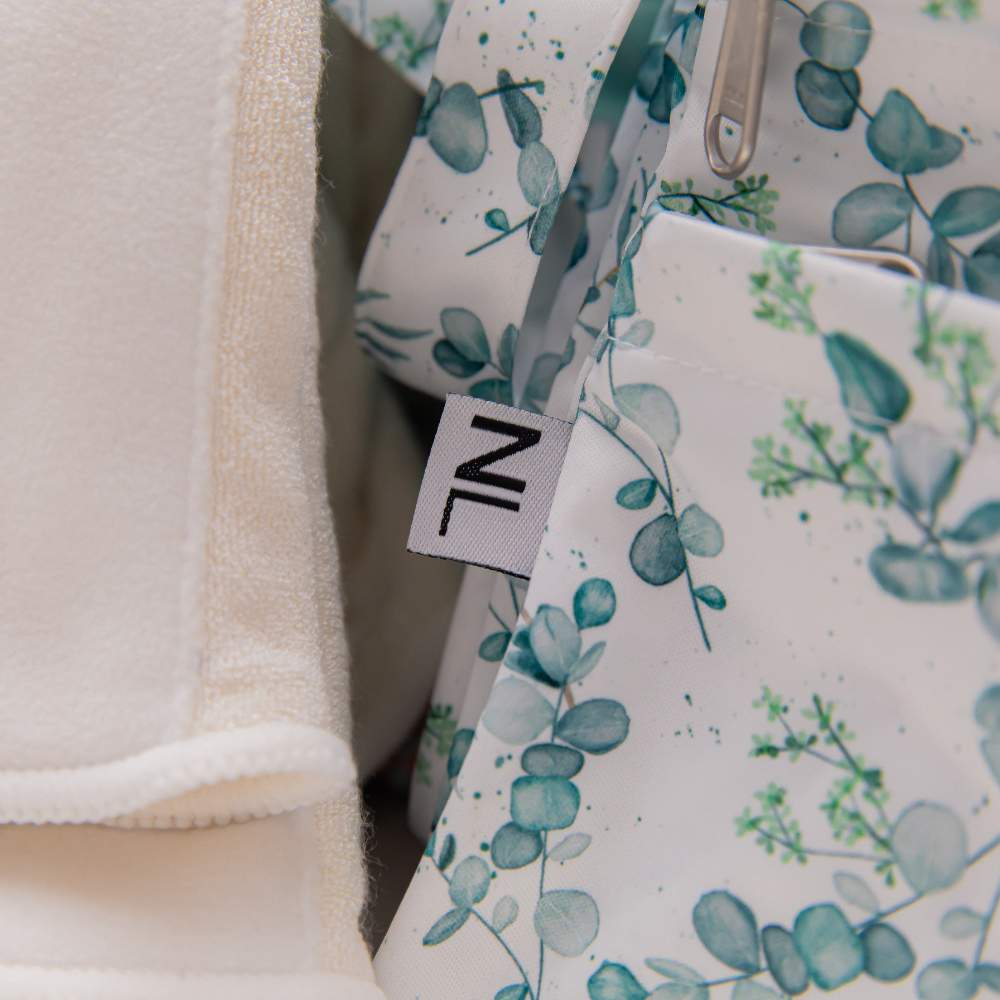 Close up of Eucalyptus wet bag and NappyLuxe discreet logo on side of bag.