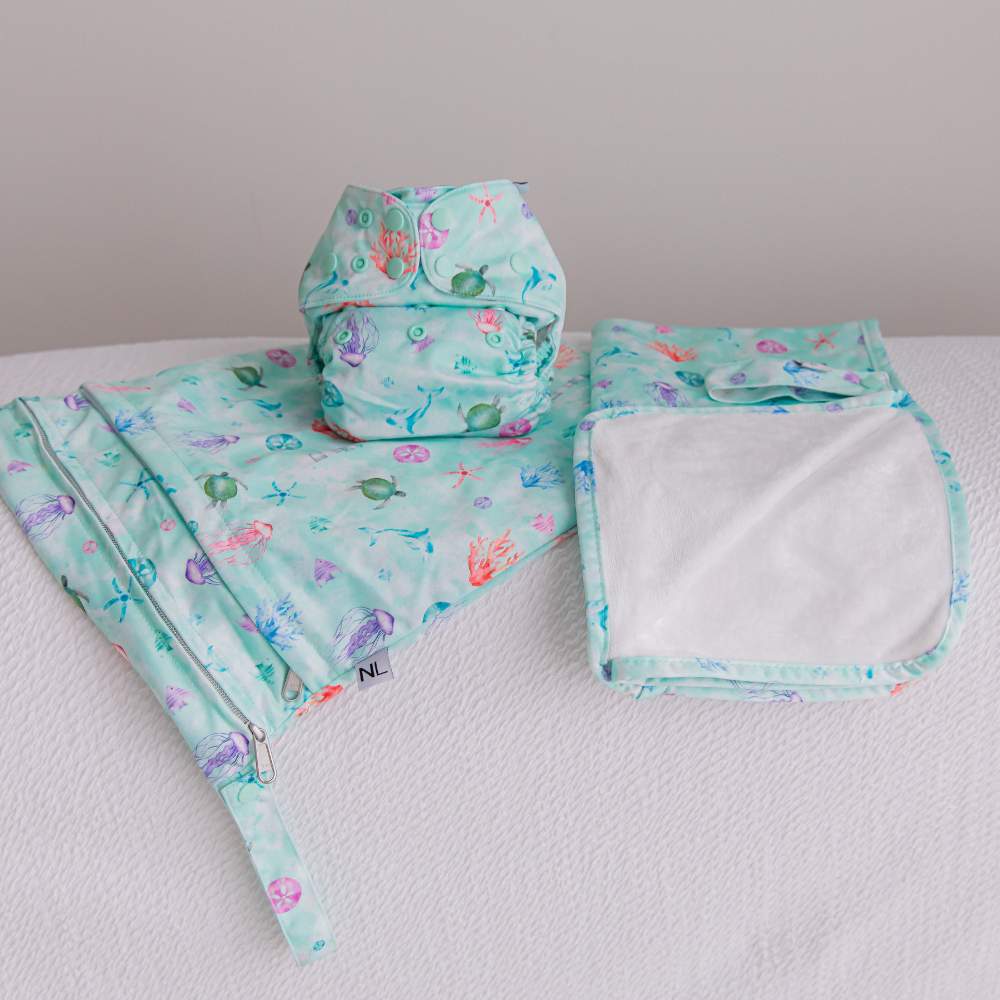 Matching Oceanic cloth nappy set including change mat, wet bag and cloth nappy