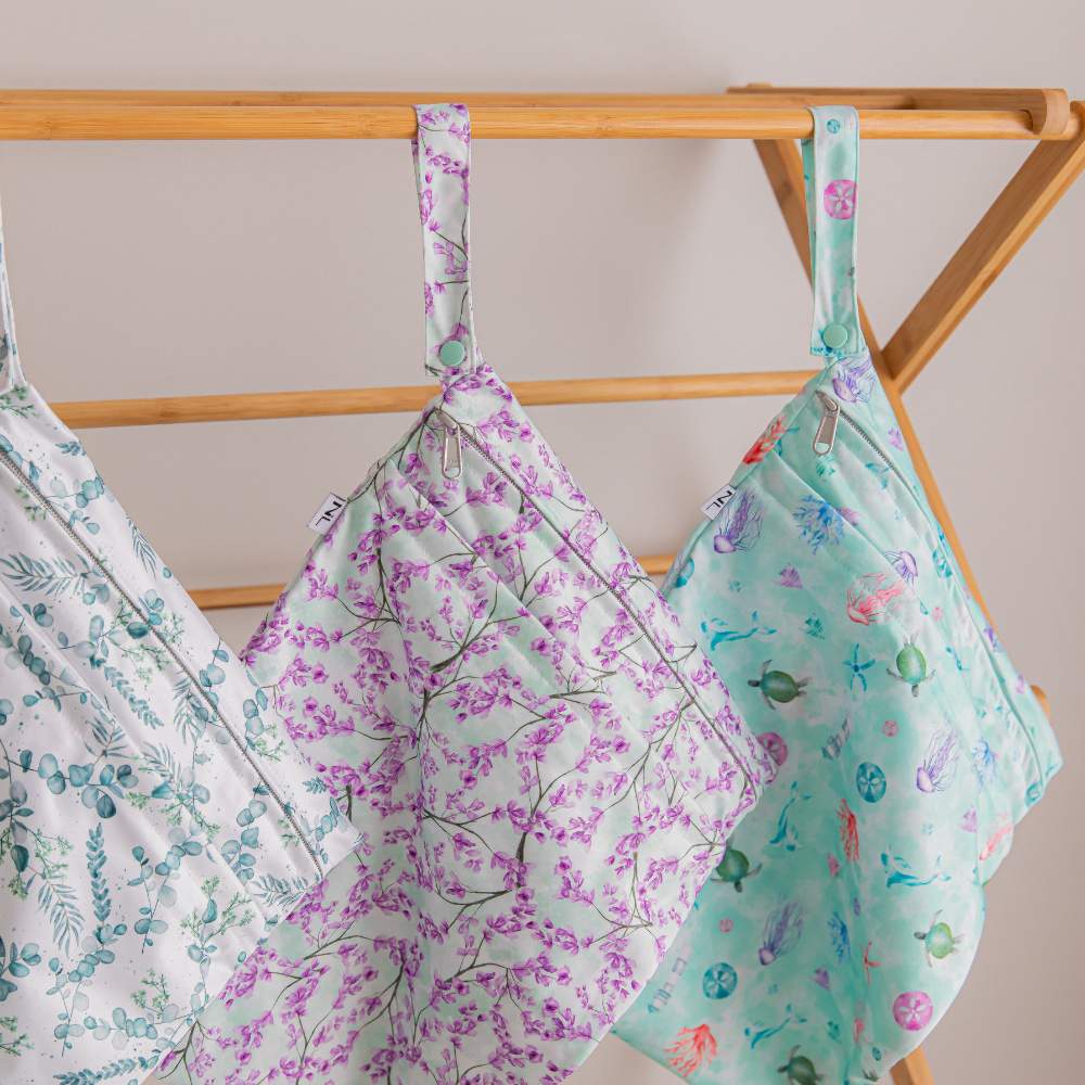 Image shows 3 wet bags hanging from wooden clothes horse