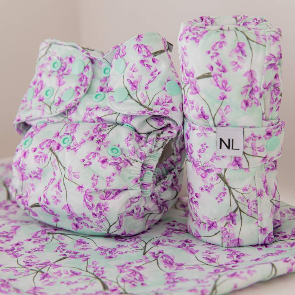 Jacaranda bloom matching set including reusable nappy, portable changing mat, and wet bag