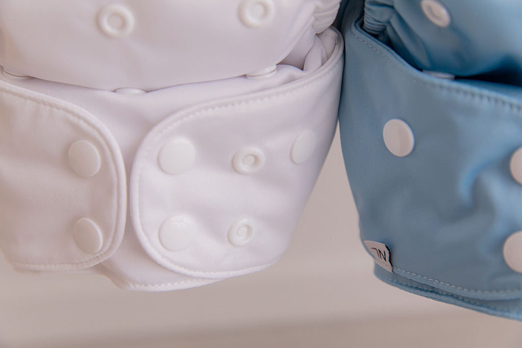 close up of two cloth nappies, one white and the other blue