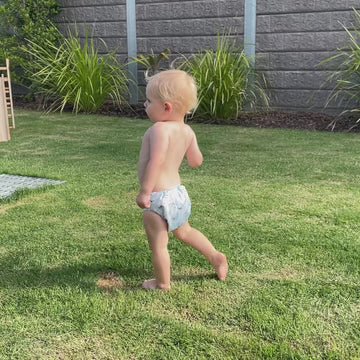 NappyLuxe customer describing what she Iikes about cloth nappies and showing her son playing in the yard wearing his cloth nappy