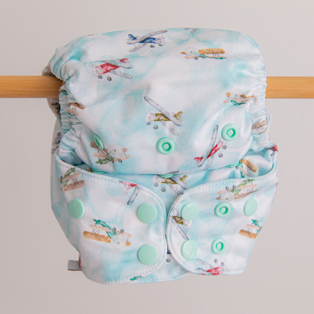 In flight blue retro aeroplanes cloth nappy hanging on wooden line